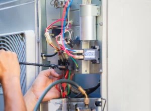 electrician fixing wirings using screwdriver checking for problem littleton CO